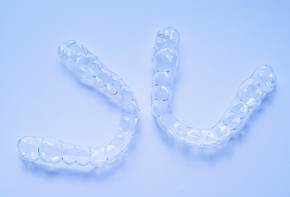 Clear aligners trays used in the UK for teeth straightening, showing transparent removable dental aligners for mild to moderate orthodontic treatment.