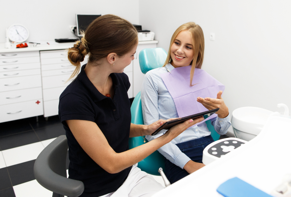 Woman consulting with a dentist about her clear aligner treatment plan during an in-clinic dental appointment in the UK.
